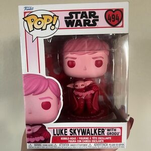 Luke Skywalker with Grogu Funko Pop in box.